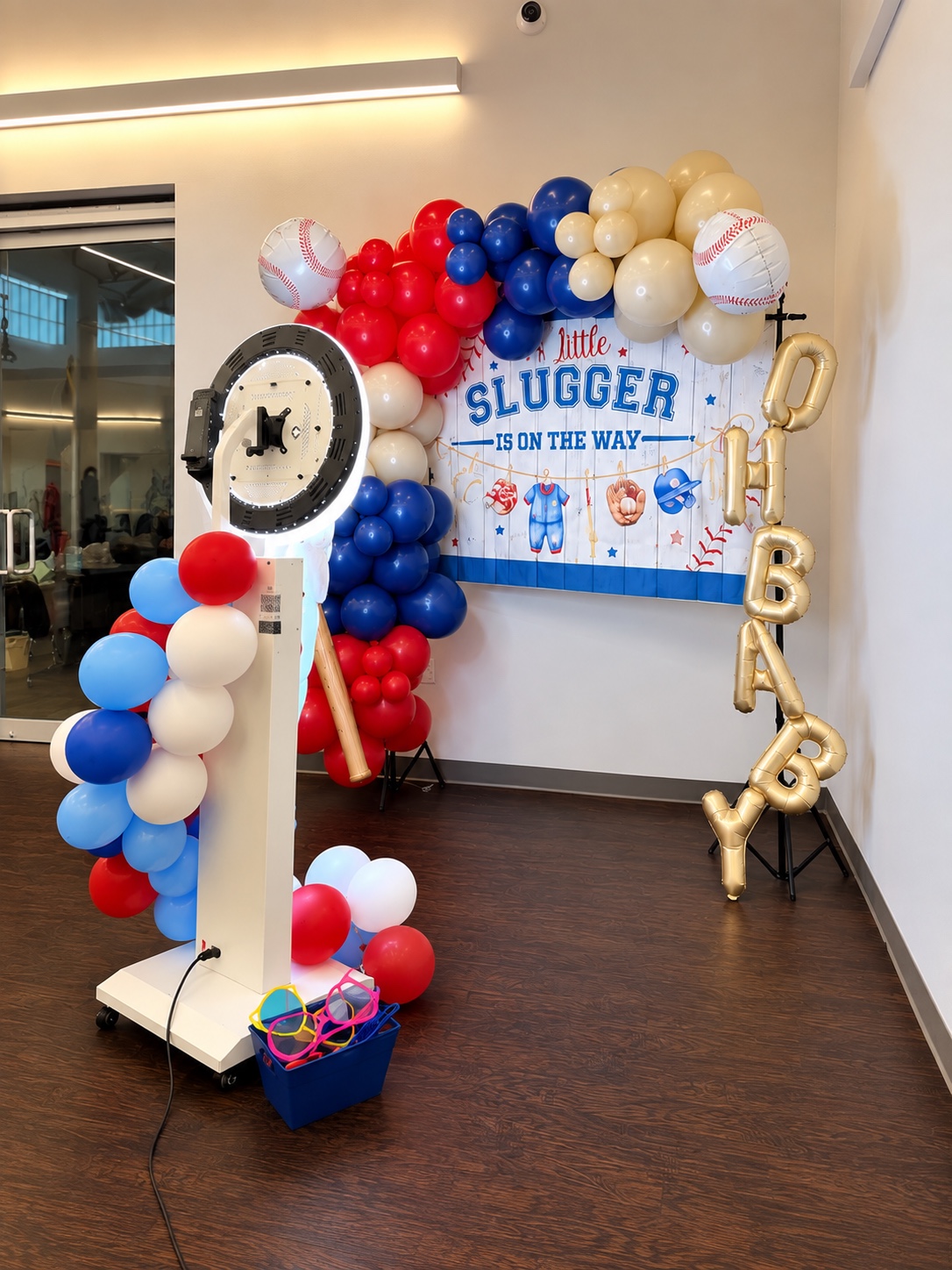 Photo booth and balloon display at a baseball-themed celebration